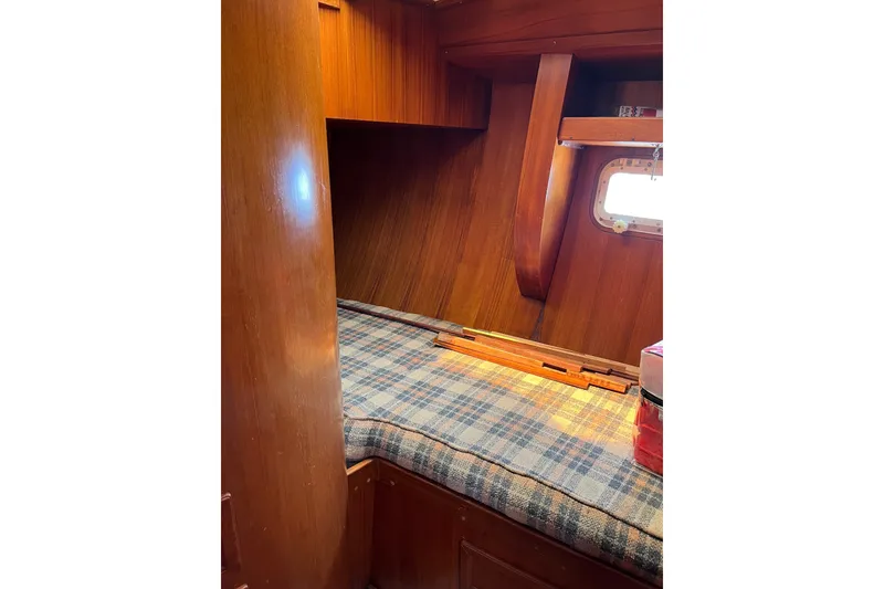Slide: The Image of Cozy cabin interior of 1980 Cheoy Lee 43 Pilot House with wooden finish and plaid bedding. - 86