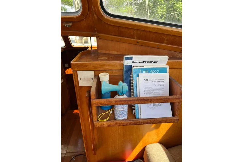 Slide: The Image of Interior of 1980 Cheoy Lee 43 Pilot House with manuals and a blue air horn. - 38