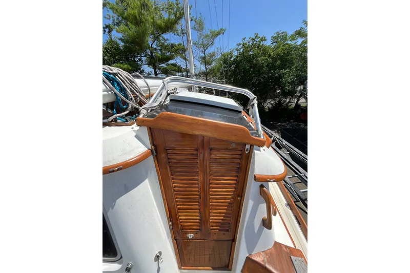Slide: The Image of 1980 Cheoy Lee 43 Pilot House sailboat with wooden hatch and rigging, docked outdoors. - 26