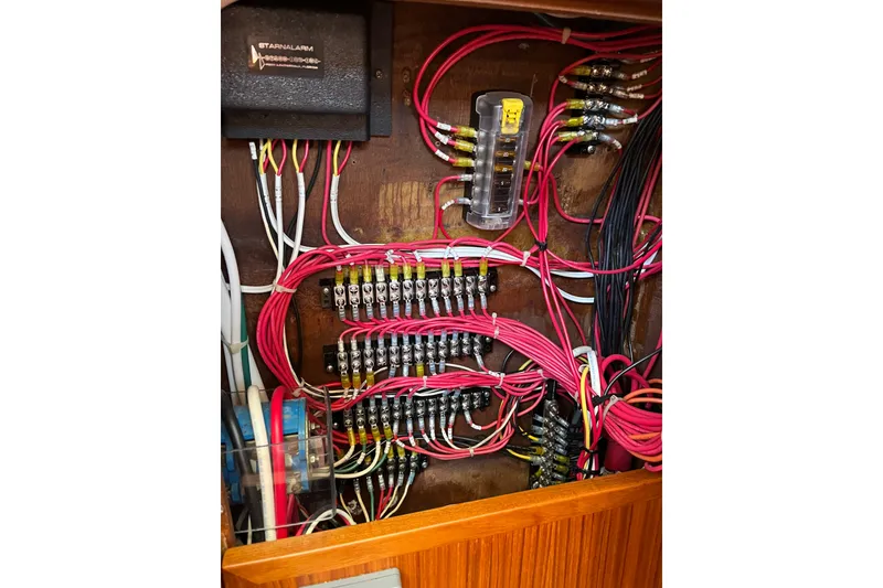 Slide: The Image of Electrical wiring panel inside a 1980 Cheoy Lee 43 Pilot House boat. - 80