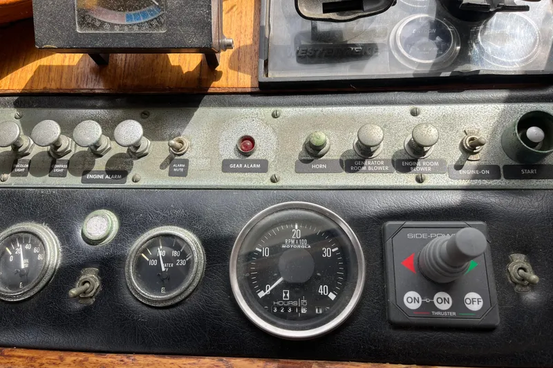 Slide: The Image of Control panel of a 1980 Cheoy Lee 43 Pilot House boat with gauges and switches. - 32