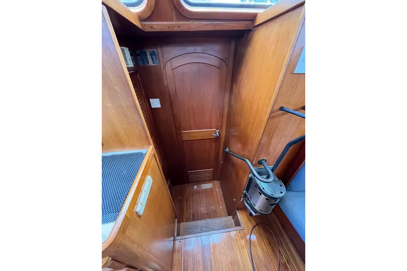 Slide: The Image of Interior of 1980 Cheoy Lee 43 Pilot House with wooden paneling and nautical equipment. - 54