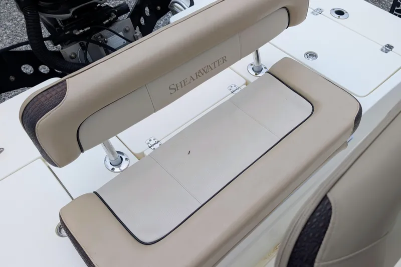 Slide: The Image of ShearWater 2200X 2010 boat seat with beige upholstery and logo detail. - 5