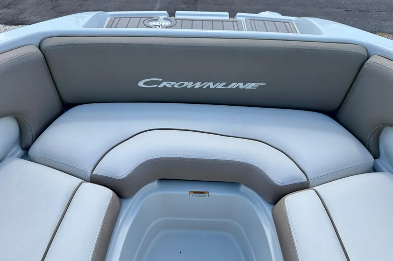 Slide: The Image of 2023 Crownline Eclipse E235 XS boat seating with logo, featuring comfortable upholstery. - 11