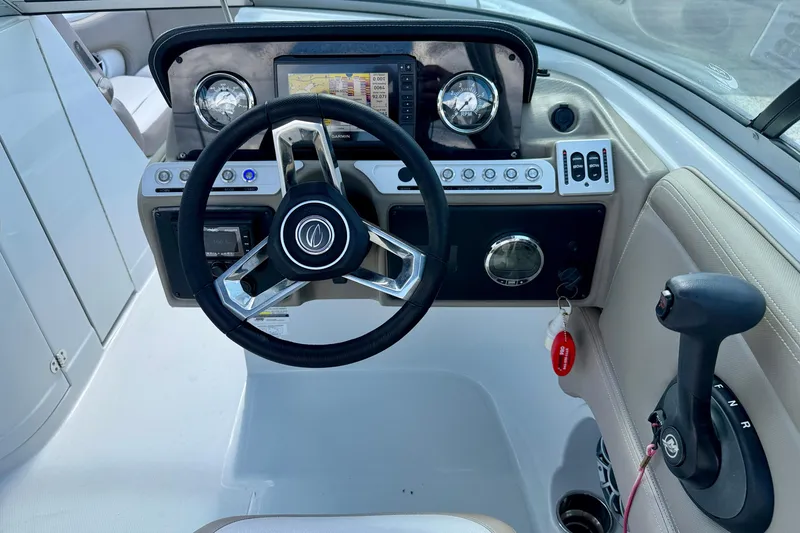 Slide: The Image of 2023 Crownline Eclipse E235 XS boat dashboard with steering wheel and controls. - 15