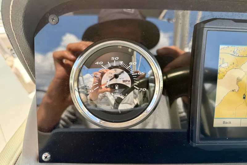 Slide: The Image of Dashboard of 2023 Crownline Eclipse E235 XS with speedometer and navigation display. - 16