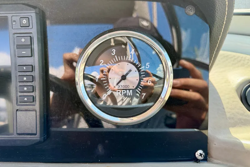 Slide: The Image of Close-up of 2023 Crownline Eclipse E235 XS RPM gauge and control panel. - 17