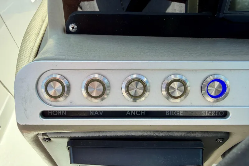 Slide: The Image of Control panel of 2023 Crownline Eclipse E235 XS boat with labeled buttons. - 19