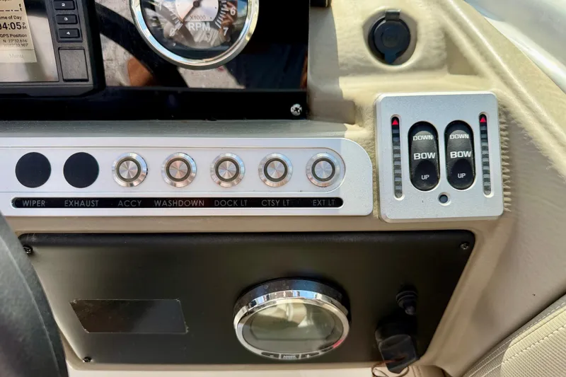 Slide: The Image of Dashboard controls of 2023 Crownline Eclipse E235 XS boat, featuring switches and gauges. - 20