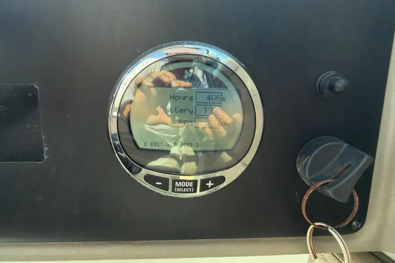 Slide: The Image of Dashboard of 2023 Crownline Eclipse E235 XS showing hours and battery status. - 22