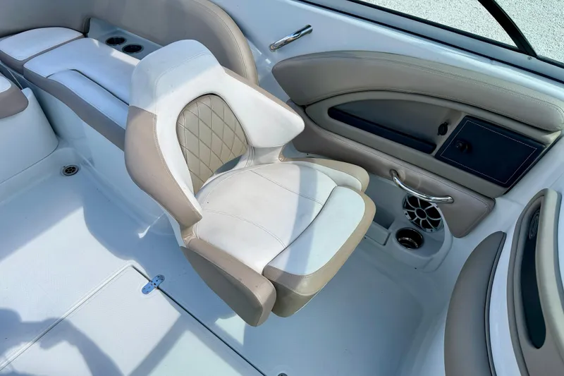 Slide: The Image of 2023 Crownline Eclipse E235 XS boat interior with beige seating and modern design. - 25
