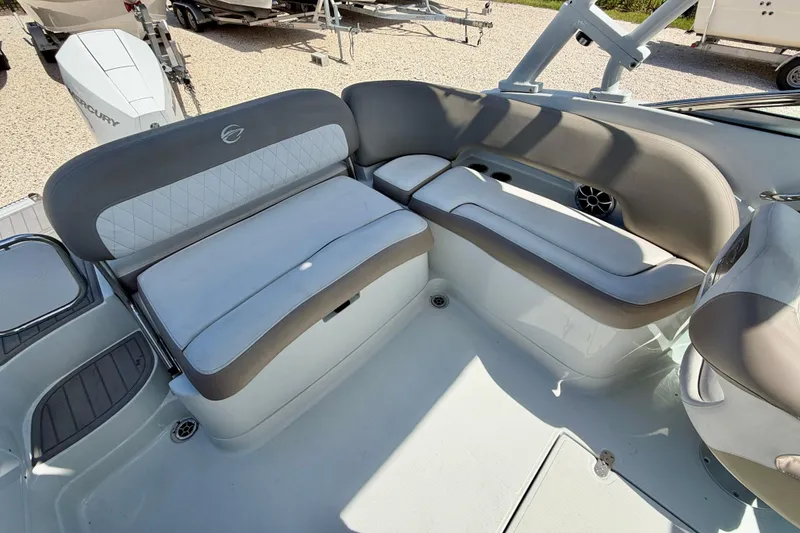 Slide: The Image of 2023 Crownline Eclipse E235 XS boat interior with cushioned seating and modern design. - 26