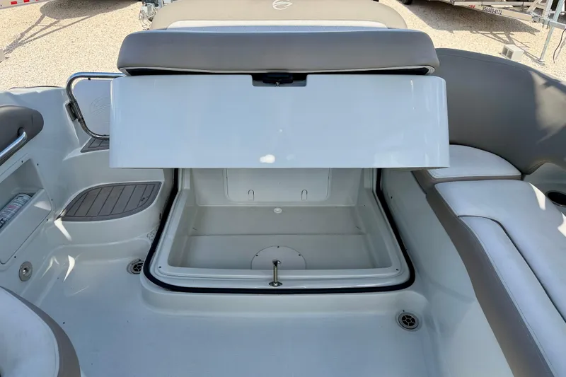Slide: The Image of 2023 Crownline Eclipse E235 XS boat interior storage compartment open. - 30