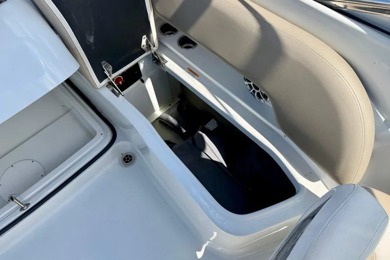 Slide: The Image of 2023 Crownline Eclipse E235 XS boat interior storage compartment open. - 31