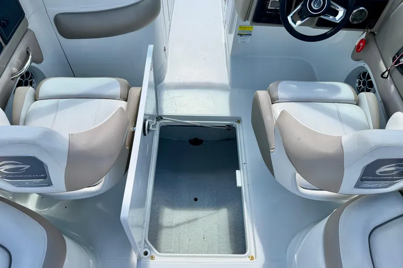 Slide: The Image of 2023 Crownline Eclipse E235 XS boat interior with open storage compartment and seating. - 33