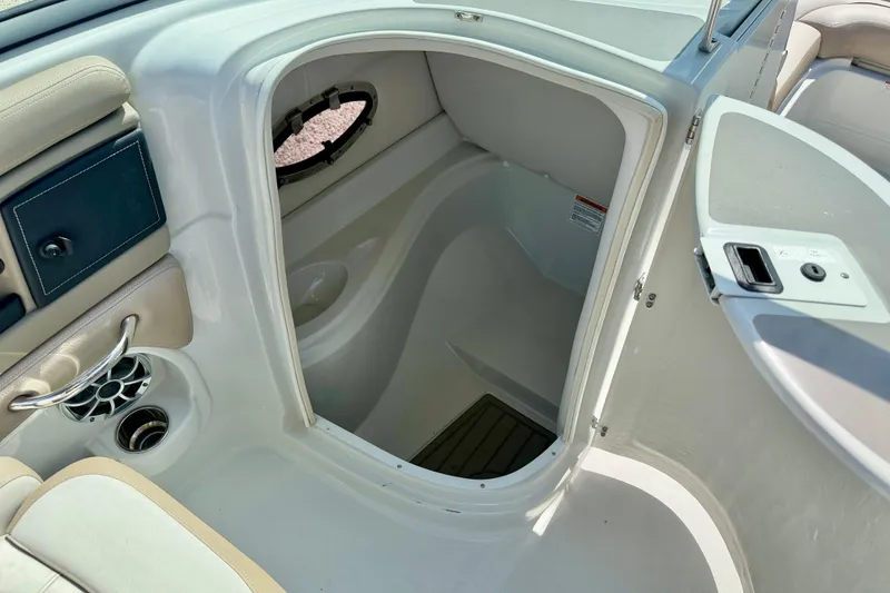 Slide: The Image of 2023 Crownline Eclipse E235 XS boat interior with open storage compartment. - 34