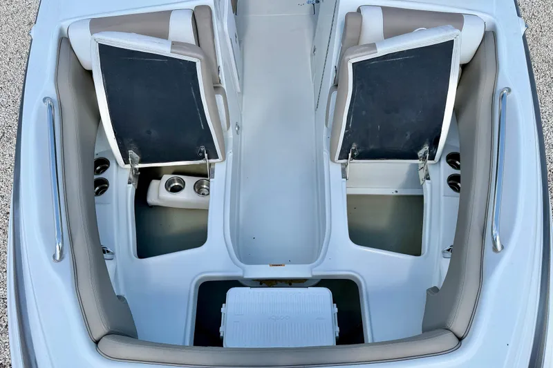 Slide: The Image of 2023 Crownline Eclipse E235 XS boat interior with open storage compartments and seating. - 35