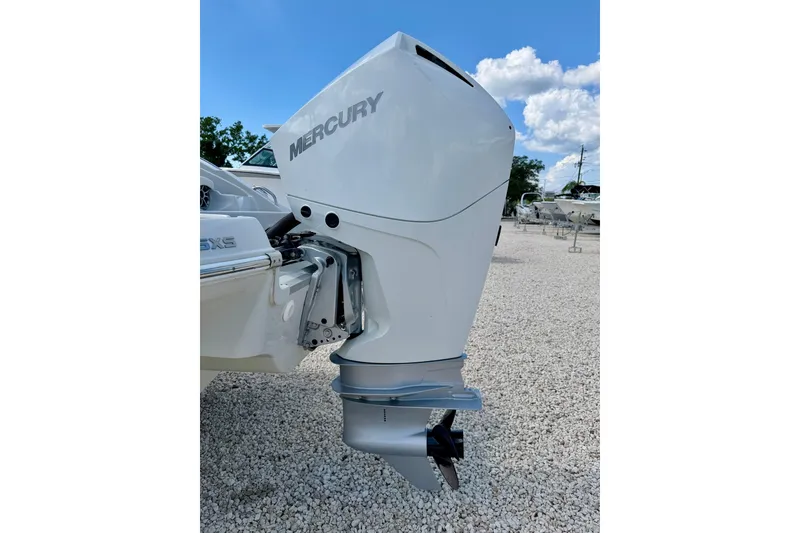 Slide: The Image of 2023 Crownline Eclipse E235 XS with Mercury outboard motor on gravel lot. - 38