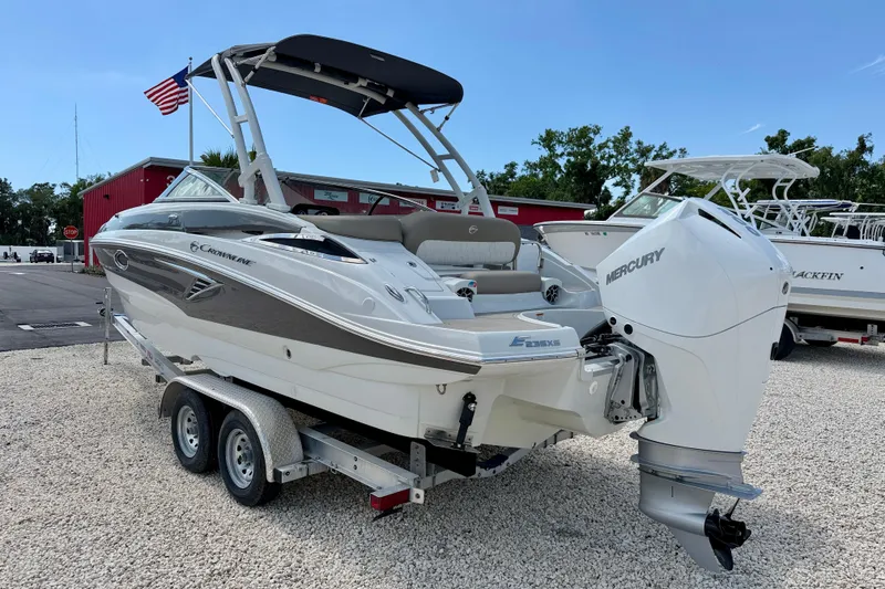 Slide: The Image of 2023 Crownline Eclipse E235 XS boat with Mercury engine on trailer, parked outdoors. - 7