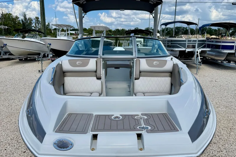 Slide: The Image of 2023 Crownline Eclipse E235 XS boat with spacious seating, displayed outdoors. - 8