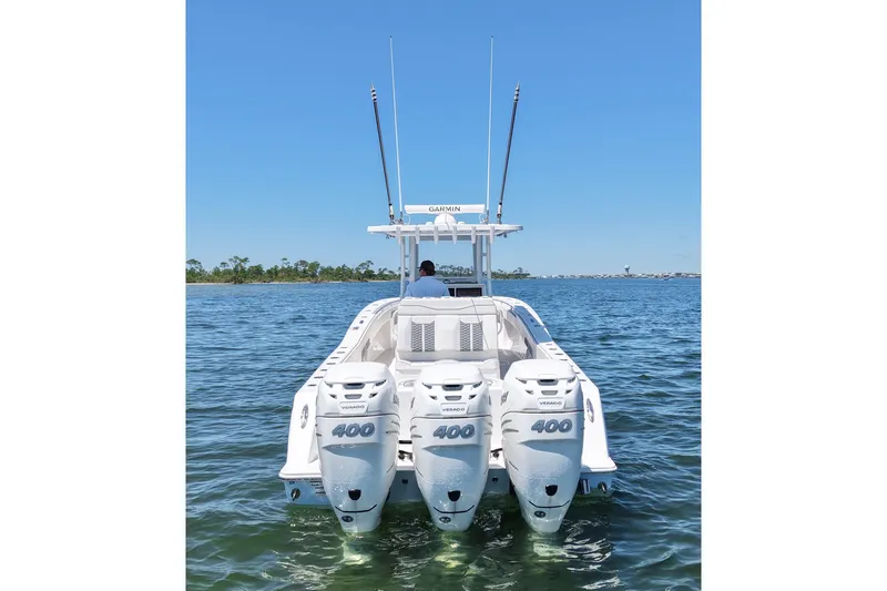 Slide: The Image of 2023 Invincible 36 Open Fisherman boat with triple 400 horsepower engines on open water. - 10
