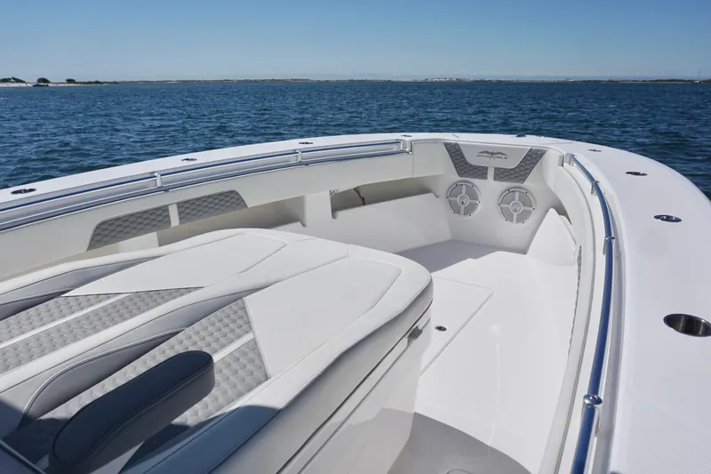 Slide: The Image of 2023 Invincible 36 Open Fisherman boat interior with cushioned seating and ocean view. - 14