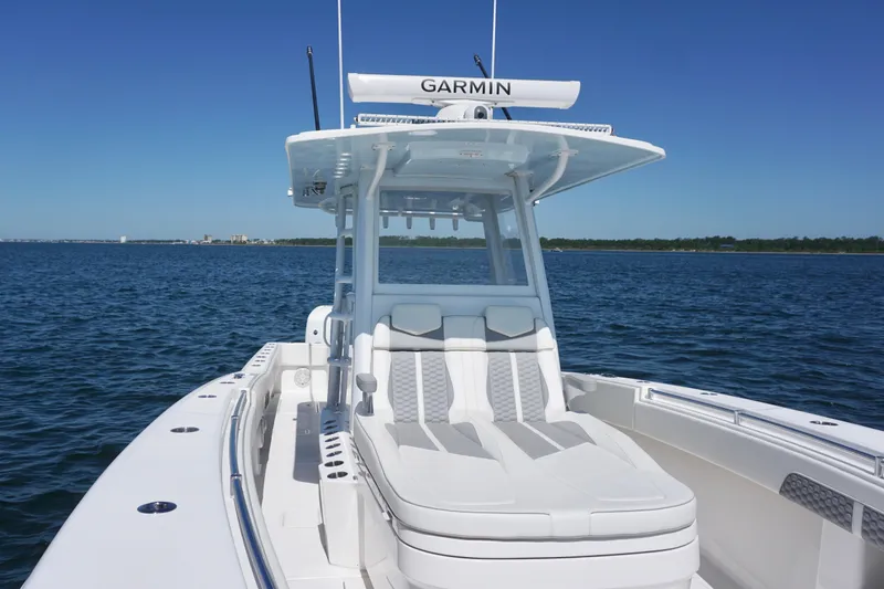 Slide: The Image of 2023 Invincible 36 Open Fisherman boat on calm blue water, featuring sleek design and advanced Garmin technology. - 15