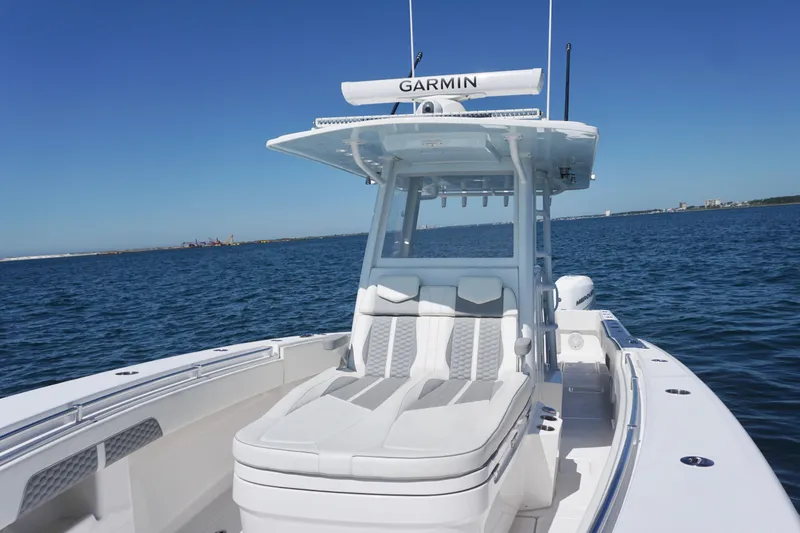 Slide: The Image of 2023 Invincible 36 Open Fisherman boat on open water, featuring Garmin equipment. - 17