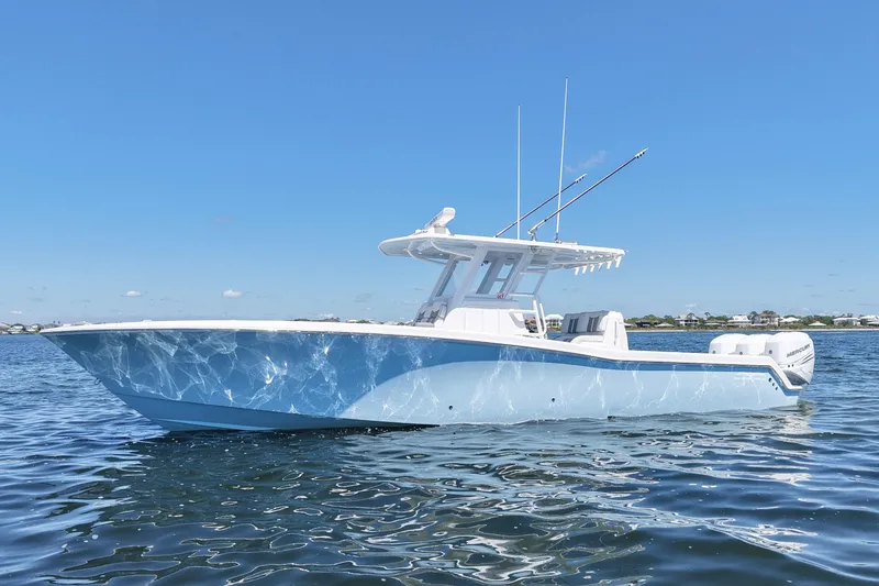 Slide: The Image of 2023 Invincible 36 Open Fisherman boat on calm water under clear blue sky. - 2
