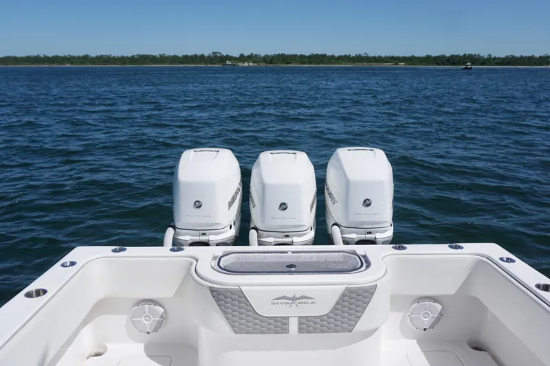 Slide: The Image of 2023 Invincible 36 Open Fisherman boat with triple outboard engines on open water. - 23