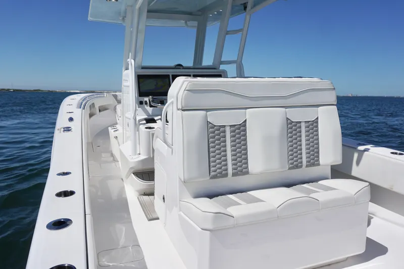 Slide: The Image of 2023 Invincible 36 Open Fisherman boat interior with sleek seating and ocean backdrop. - 28