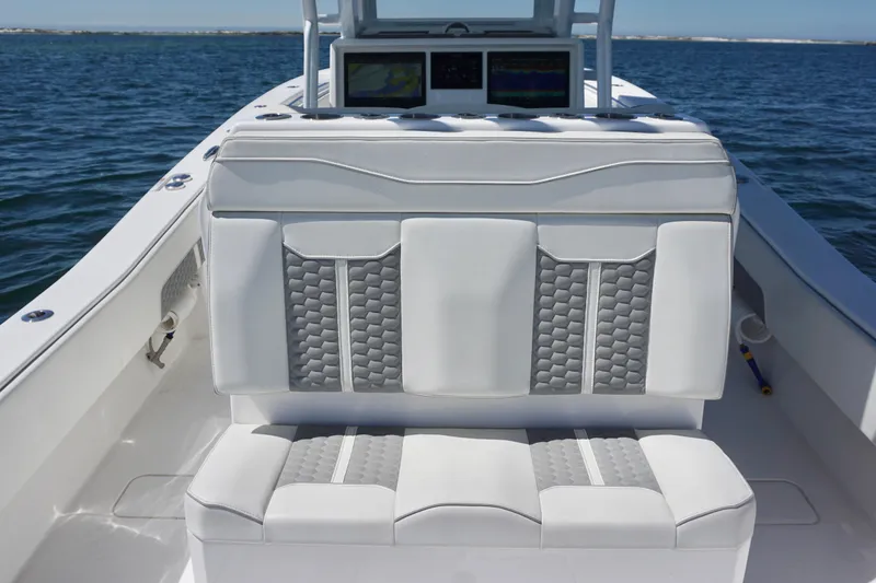 Slide: The Image of 2023 Invincible 36 Open Fisherman boat interior with cushioned seating on open water. - 30