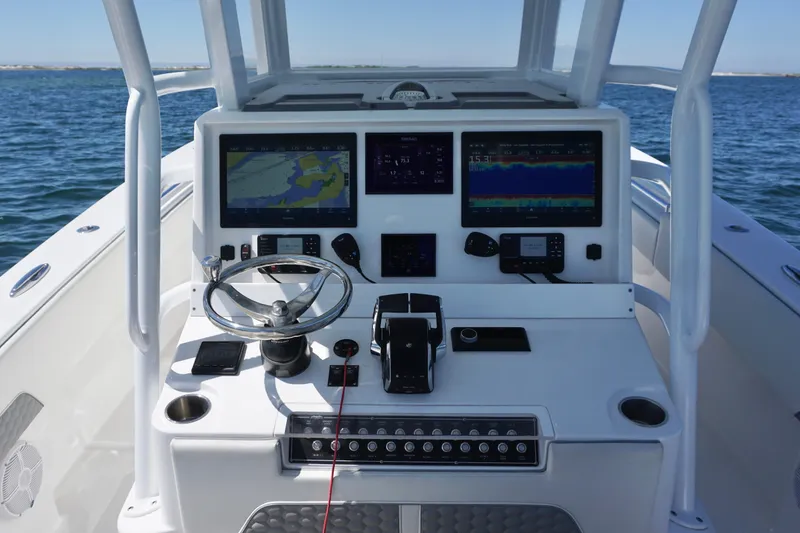 Slide: The Image of 2023 Invincible 36 Open Fisherman boat dashboard with navigation screens and steering wheel. - 32