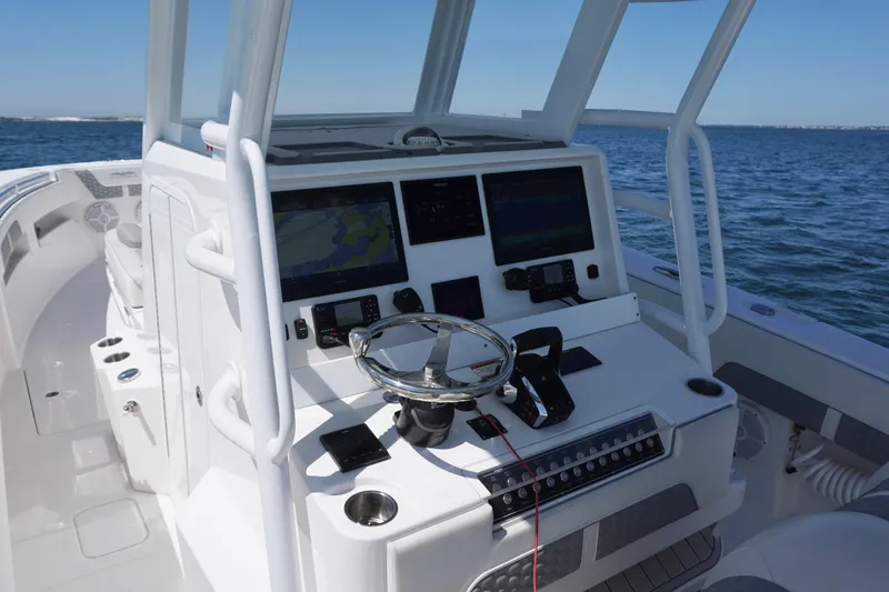Slide: The Image of 2023 Invincible 36 Open Fisherman boat dashboard with advanced navigation systems on open water. - 34