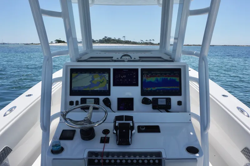 Slide: The Image of 2023 Invincible 36 Open Fisherman boat dashboard with navigation screens on open water. - 35