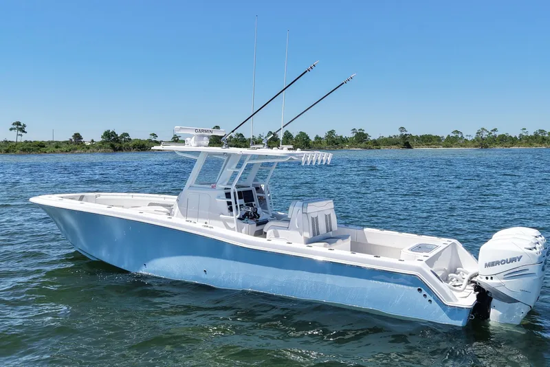 Slide: The Image of 2023 Invincible 36 Open Fisherman boat on calm water, featuring dual Mercury engines. - 5