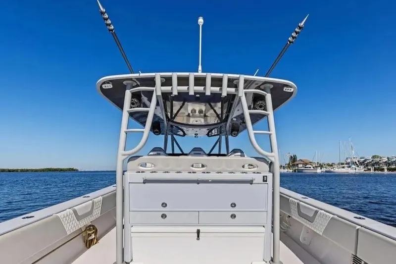 Slide: The Image of 2022 Contender 44 CB boat with fishing rods, on calm blue water under clear sky. - 10