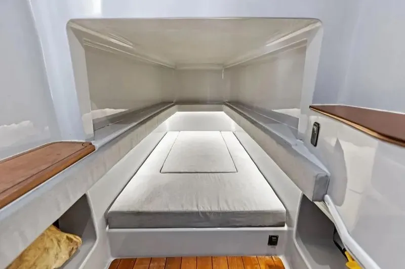 Slide: The Image of 2022 Contender 44 CB cabin interior with sleek design and comfortable bedding. - 20