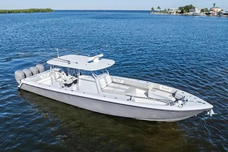 Slide: The Image of 2022 Contender 44 CB boat on calm blue water, featuring multiple outboard engines. - 4
