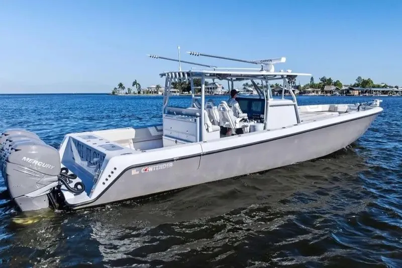 Slide: The Image of 2022 Contender 44 CB boat on water with Mercury engines, clear blue sky. - 5