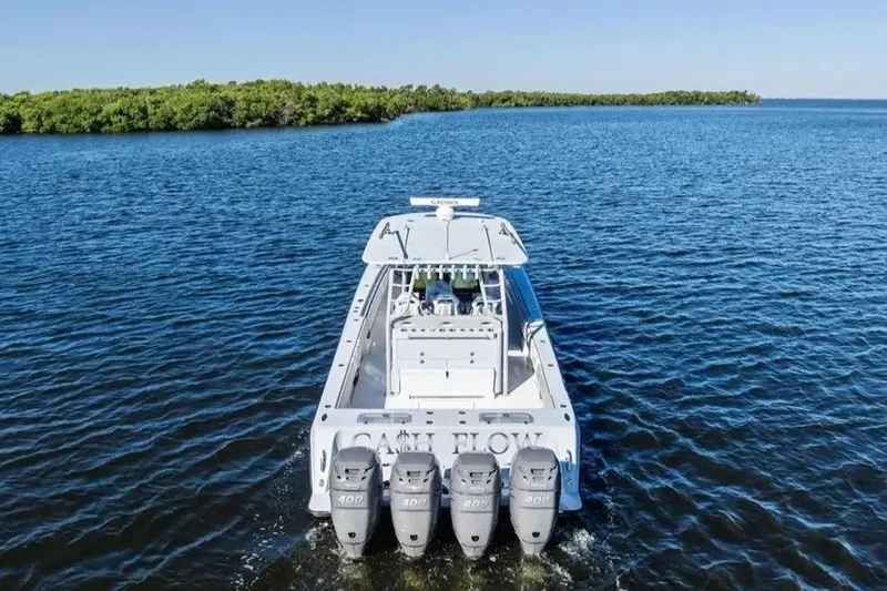 Slide: The Image of 2022 Contender 44 CB boat with four engines cruising on open water. - 7