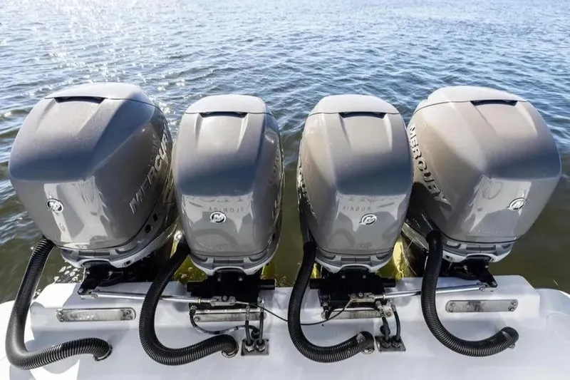 Slide: The Image of Four Mercury outboard engines on a 2022 Contender 44 CB boat, on water. - 8