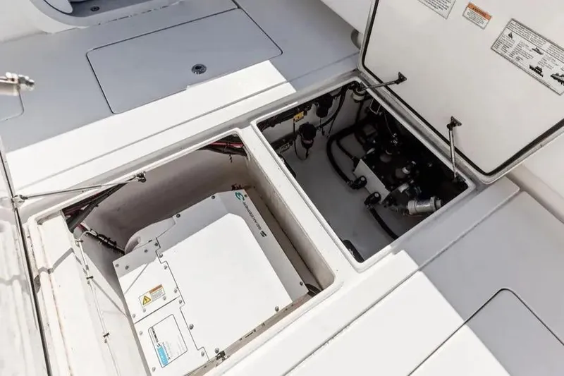 Slide: The Image of Open compartments on a 2022 Contender 44 CB boat, revealing mechanical components. - 9