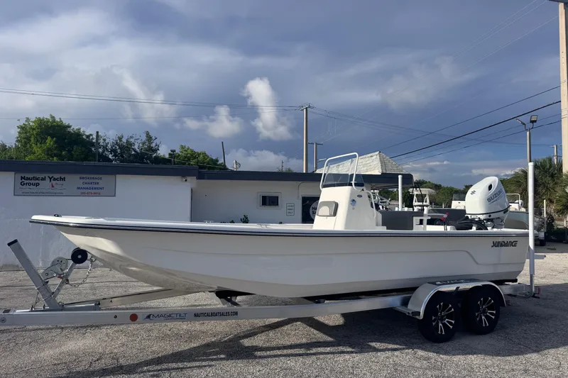 The Image of 2026 Sundance B22CCR boat on trailer, parked outside Nautical Yacht Group building. - 0