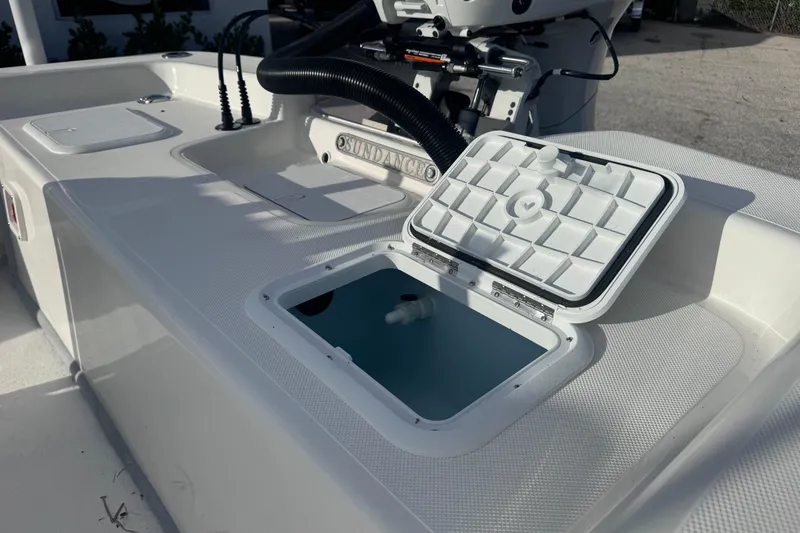 Slide: The Image of Open hatch on 2026 Sundance B22CCR boat, showcasing storage compartment. - 10