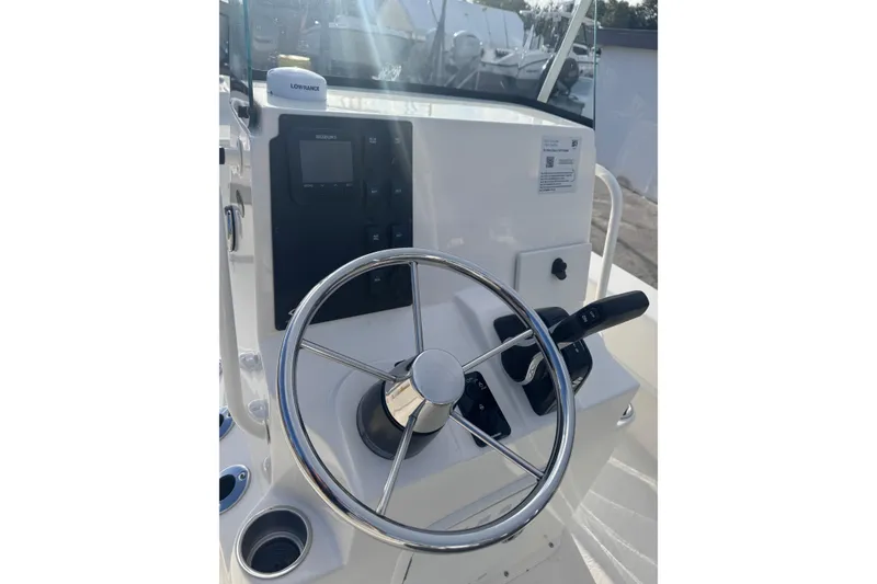 Slide: The Image of Steering console of 2026 Sundance B22CCR boat with modern controls and navigation equipment. - 12