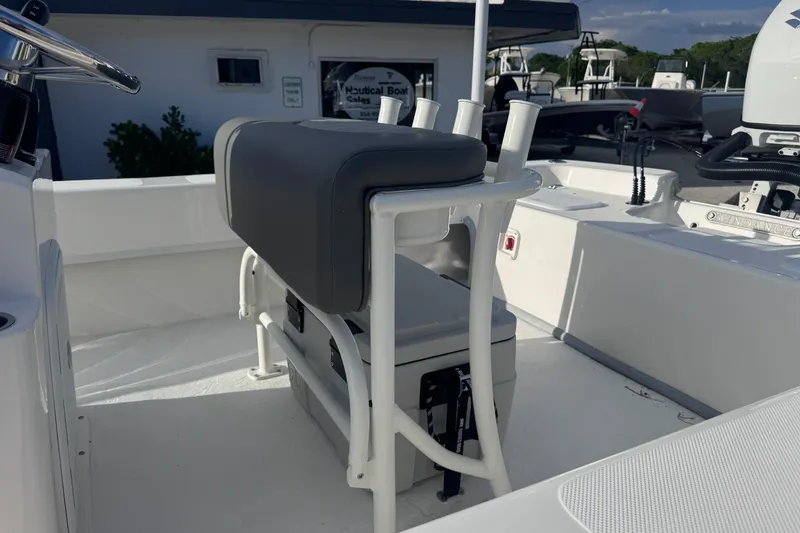 Slide: The Image of 2026 Sundance B22CCR boat interior with seating and rod holders. - 9
