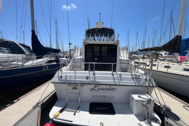 Slide: The Image of 1989 Carver 3297 Mariner docked in San Pedro marina, surrounded by sailboats. - 1