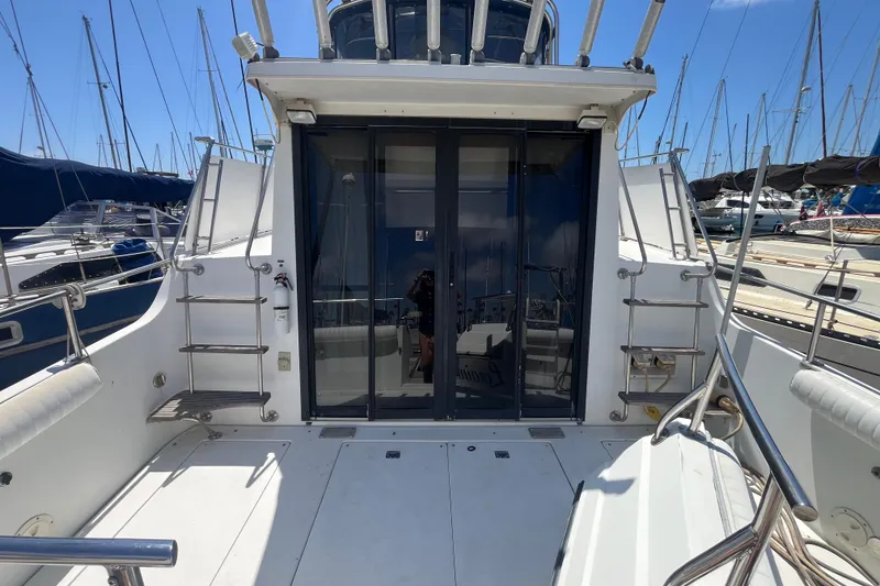 Slide: The Image of 1989 Carver 3297 Mariner yacht deck with sliding glass doors and marina view. - 10