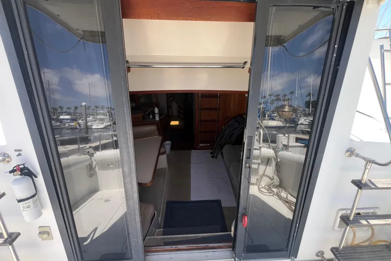 Slide: The Image of Interior view of 1989 Carver 3297 Mariner yacht with marina reflections. - 11